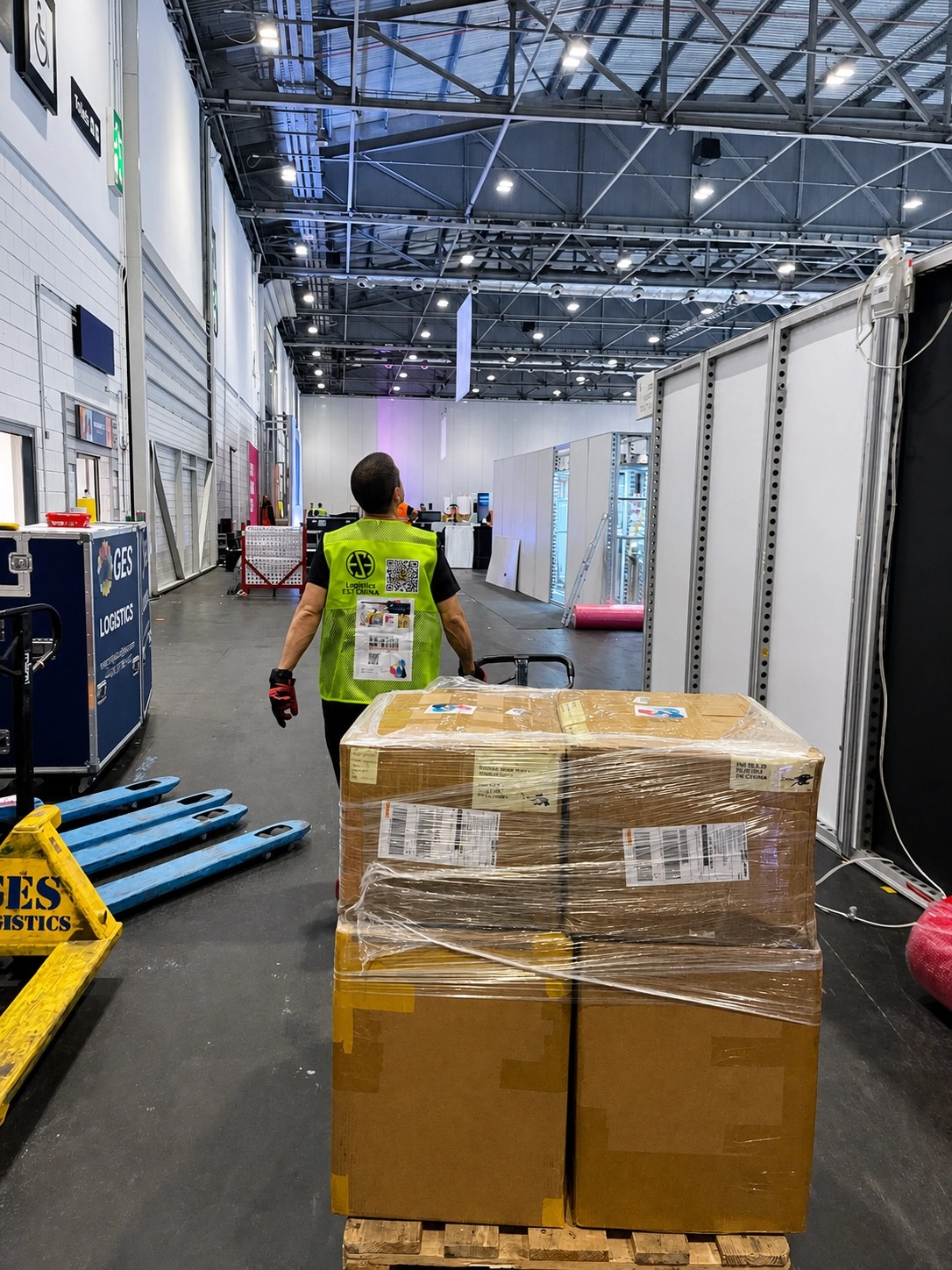 QM Transport at an ExCeL London trade show, delivering a wrapped pallet to an exhibitor stand